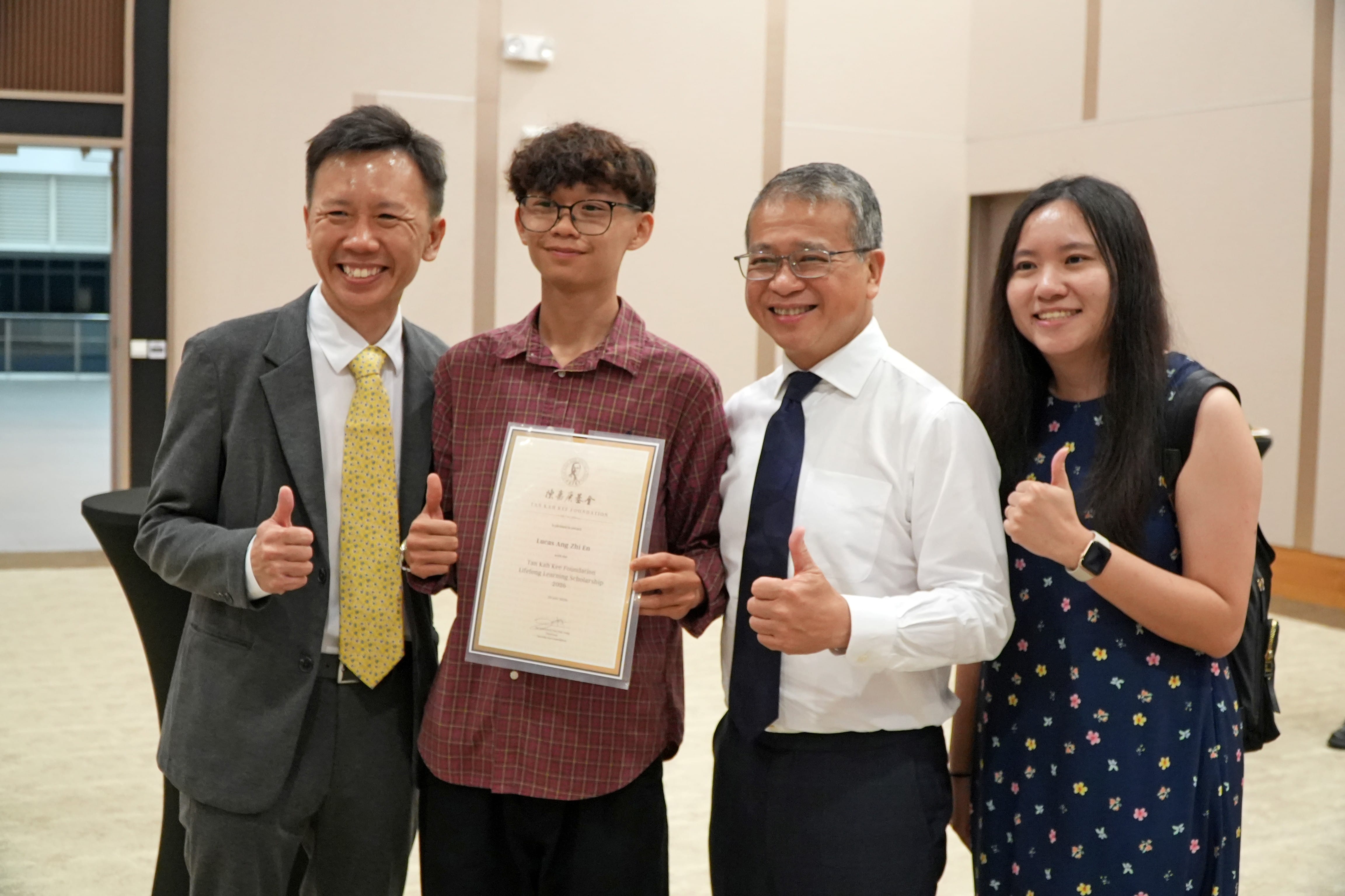 Scholarship recipient posing with family and GOH